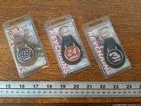 All three packaged NASCAR keychains with ruler for scale