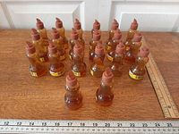 Front view of 20 LePage Mucilage bottles showing labels and caps