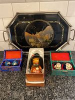 Group shot showing lacquer tray, kokeshi doll, two baoding ball sets