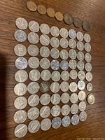 Full layout of mixed Canadian coins on wood surface