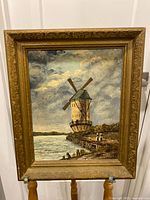 Full view of framed windmill painting