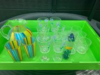 Full lot on green tray showing pitcher, tumblers, goblets and stir sticks