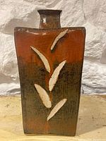 Full front view of vase showing shape, glaze and leaf motif