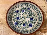 Overall view of round pottery dish showing complete pattern and rim