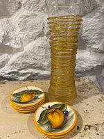 full view of vase and stack of plates