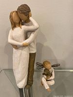 Couple figurine with child angel figurine below