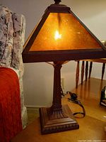 Lamp lit showing amber mica shade and bronze base