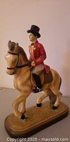 Left front view of figurine showing rider, horse and base