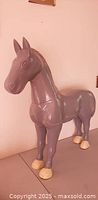 Front and side view of gray horse figurine with cream hooves