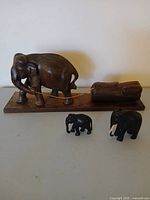 All three elephant figurines together showing relative sizes and finishes