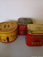 Group shot of three vintage advertising tins