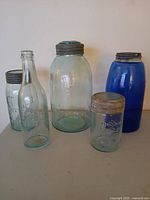Group shot of five containers showing sizes, colors and lids