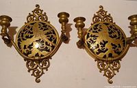 Pair of brass heraldic lion wall sconces front view