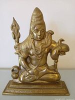 Front view of seated brass Lord Shiva with trident and cobra on rectangular plinth