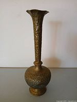 Full view of tall brass trumpet-neck vase