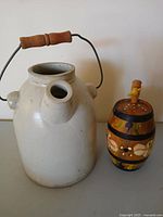 Stoneware jug and wooden keg side by side