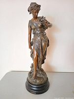 Front view of spelter sculpture showing figure, dove, drapery and base