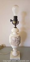 Full view of alabaster table lamp with bulb installed