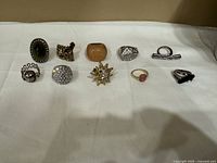 All ten rings laid out on white cloth