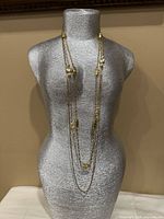 All three necklaces layered on mannequin showing design elements