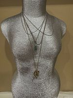 All five necklaces layered on mannequin bust showing overall appearance