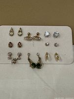 Front view of all eight earring pairs on display card