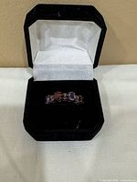 Ring in presentation box showing gemstone arrangement