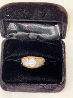 Ring in open velvet box showing stone and textured shoulders