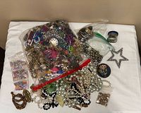 Full view of lot showing bag of jewellery and loose items