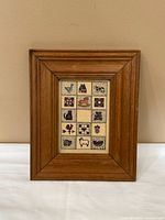 Front view showing entire wooden frame and interior folk art print.