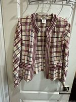 Front view of plaid knit jacket on hanger