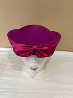 Front view showing hat shape, color and bow