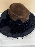 Top angle showing brown felt crown and black brim with veil