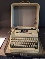 Typewriter seated in open hard case showing overall condition