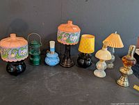 Group view of eight Avon lamp-shaped perfume bottles