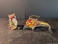 both blown glass bird figurines side by side