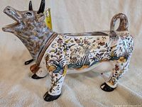 Hand-painted floral cow-shaped gravy boat side view