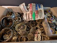 overview of box showing bangles, findings, bead card, purple cabochon earrings