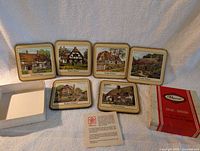 All six coasters displayed with box and leaflet