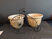 Overall view of two planters and metal bicycle decor