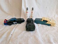 group shot of all three car bottles and two spark plug decanters