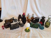 All eleven figural Avon decanters displayed on white backdrop