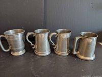 All four pewter tankards lined up