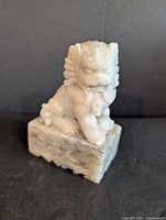 Front view of soapstone Chinese dog statue on base