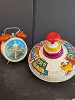 Overall view of spinning top and alarm clock