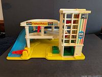 Front view showing overall garage, ramp, elevator, service island