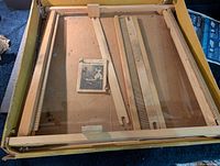 Disassembled wooden loom, reeds, shuttle and booklet inside box
