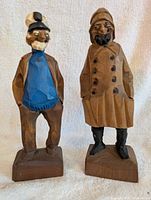 Front view of both wooden fishermen statues