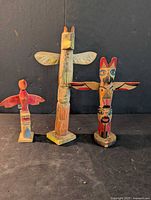 Front view of all three wooden totem poles
