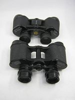 Two binoculars frontal view showing overall design and size